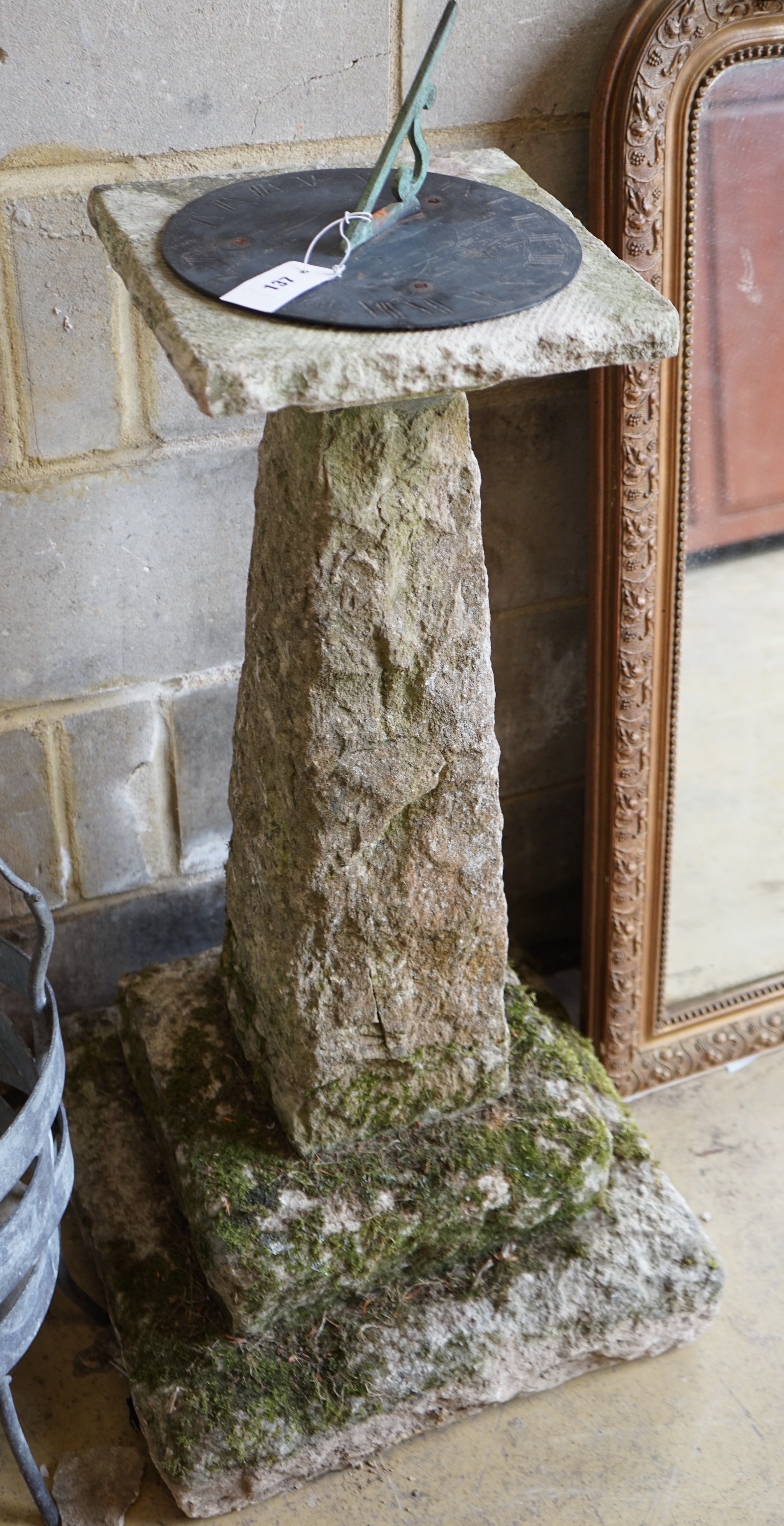 A carved stone sundial with brass dial and gnomon, height 105cm